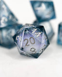 Close-up of polyhedral dice with a blue and gray gradient on a white background