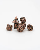 Set of metallic dice with intricate designs on a white background