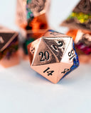 Close-up of a metallic polyhedral dice with numbers on a blurred background
