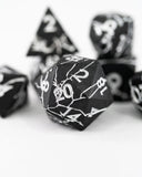 Black dice with white text on a white background