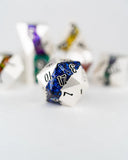 Close-up of a dice with blue and silver glitter, surrounded by other dice on a light background