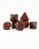 Set of black dice with red numbers on a white background