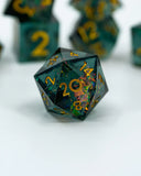 Close-up of a dark green polyhedral dice with gold numbers on a white background