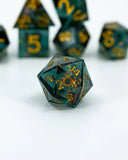 Set of polyhedral dice with green and gold colors on a white background