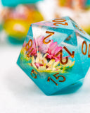 D20 polyhedral dice with floral design and turquoise color on a white background