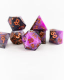Set of purple and orange polyhedral dice on a white background