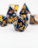 Blue and gold polyhedral dice set on a white background