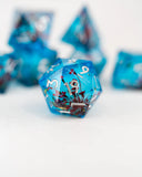 Blue polyhedral dice set with floral design on a white background