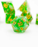Green polyhedral dice with yellow numbers on a white background