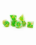 Set of green dice with gold numbers on a white background