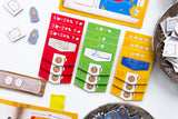Colorful math flashcards and educational materials on a white surface