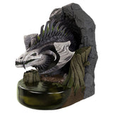 Dragon sculpture on a rocky base with a white background