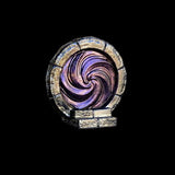 Decorative swirl design in a circular frame on a black background