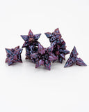 Purple metallic star-shaped dice on a white background
