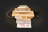 Stack of documents titled 'Family Secrets' with a pen on a dark background