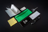 Collection of stationery items including a phone, pen, envelope, and cards on a dark background