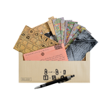 Collection of stationery items including cards, envelopes, and a pen on a white background