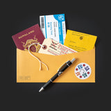 Passport, tickets, and letter on a yellow envelope with a pen on a black background