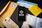 Phone displaying 'MOBILE ESCAPE' app on a surface with travel-related items.