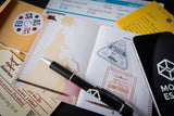 Collection of travel documents and a pen on a surface