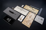 Collection of vintage-style documents, a phone, and a pen on a dark surface.