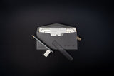 Black envelope with a letter and pen on a black background