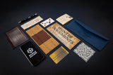 Collection of stationery items including a phone, envelopes, and cards on a dark background