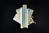 Set of rolled-up papers with gold text on a black background