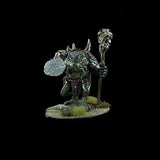 Metallic fantasy figurine with a staff on a black background