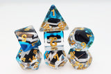 Set of polyhedral dice with blue, black, and gold design on a white background