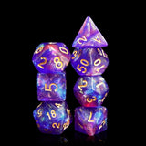 Set of purple and blue dice with gold numbers on a black background