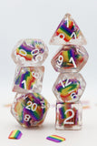 Set of rainbow-colored polyhedral dice with clear plastic, on a white background.