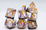 Set of dice with owl design and number markings on a white background