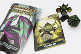 Pathfinder game components including a card with a goblin illustration, a dice, and packaging on a white background.