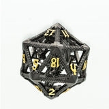 A 20-sided d20 polyhedral gaming die with a black carbon-fiber-look frame and gold-colored numerals, shown on a plain white background.