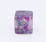 Marbled purple and pink die with numbers on a white background