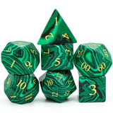 Set of green marbled dice with gold numbers on a white background