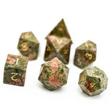 Set of polyhedral dice with a speckled green and brown design on a white background