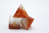 Set of polyhedral dice with gradient color and gold numbers on a white background