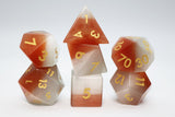 Set of polyhedral dice with red and white gradient on a white background