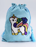 Blue drawstring bag with a colorful unicorn patch on a light gray background