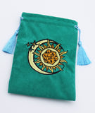 Green pouch with a sun and moon design on a blue background