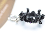 Black ring with intricate design on a white background