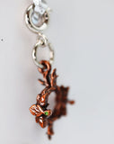 Close-up of a copper-colored leaf charm on a white background