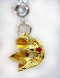 Gold-colored cat-shaped charm with a red nose on a white background