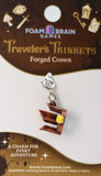 Foam Brain Games traveler's trinket charm on packaging with brand name and product description.