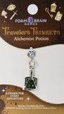 Alchemist potion charm on a Foam Brain Games card with branding and product details.