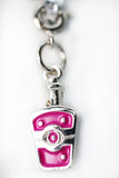 Pink and silver charm on a white background
