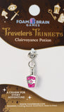Charm for 'Traveler's Trinkets' series by Foam Brain Games on a branded card.