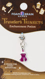 Foam Brain Games Traveler's Trinkets Enchantment Potion charm on packaging with brand name.
